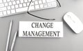 CHANGE MANAGEMENT text on paper with keyboard on grey background