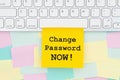 Change password now type message on a sticky note on a computer keyboard