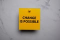 Change Is Possible write on sticky note isolated on Office Desk Royalty Free Stock Photo