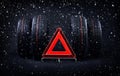 Change tires for winter advice with summer tires, snow and red emergency stop sign. Time to switch your tires Royalty Free Stock Photo