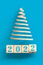 change 2021 to 2022 happy new year concept- elecant christmas tree metaphor - wooden cubes Royalty Free Stock Photo