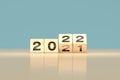 Change 2021 to 2022 happy new year concept - wooden cube  top slide cover calendar Royalty Free Stock Photo