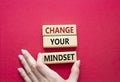 Change your mindset symbol. Concept words Change your mindset on wooden blocks. Businessman hand. Beautiful red background. Royalty Free Stock Photo