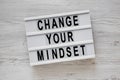 `Change your mindset` words on a lightbox on a white wooden background, top view. Overhead, from above, flat lay Royalty Free Stock Photo