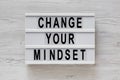 `Change your mindset` words on a modern board on a white wooden background, top view. Overhead, from above, flat lay Royalty Free Stock Photo