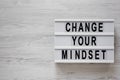 `Change your mindset` words on a modern board on a white wooden surface, top view. Overhead, from above, flat lay. Copy space Royalty Free Stock Photo