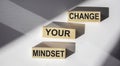 CHANGE YOUR MINDSET written on wooden blocks and white background. Motivation, positive wishes, business, finance