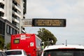 Changeable electronic dynamic road sign reads -Stay COVID safe. Keep your distance. Wash your hands- on a busy city street
