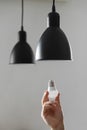 Changing the bulb for led bulb in floor lamp in black colour. On light gray background Royalty Free Stock Photo