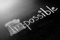 Changing impossible into possible on a chalkboard Royalty Free Stock Photo