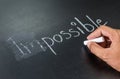 Changing impossible into possible on a chalkboard Royalty Free Stock Photo