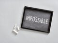 Changing impossible into possible using chalk on a blackboard Royalty Free Stock Photo