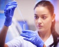 Changing lives with sound medical research. a young scientist transferring liquid from a pipette to a test tube in a Royalty Free Stock Photo