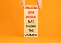 Changing mindset symbol. Concept words Changing your mindset may change the situation on wooden blocks on a beautiful orange table Royalty Free Stock Photo