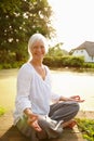 Changing my attitude towards life. Portrait of an attractive mature woman doing yoga in a beautiful garden setting. Royalty Free Stock Photo