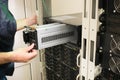 Changing the power module in the server room close-up. Working with equipment in the datacenter rack. Replacing the battery in an