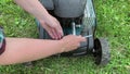 Changing replacing lawn mower spark plug, landscape equipment repair service, process of unscrewing spark plug