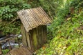 Changing room built of bamboo trunks by a river in a tropical rain forest. Small house at Spray Waterfall on Bali Island high in