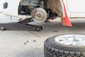 Changing a tire on a rally car in maintenance area