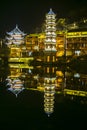 Changsha,China Feb 20, 2014 night illumination lights of FengHuang village chinese pagoda reflect on river