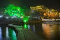 Small bamboo bridge in a river lead to an illumination lights FengHuang town at night in Changsha, China