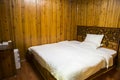 Changsha,China Feb 20, 2014 a wooden bedroom with a big bed white sheet and pillow