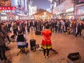 Unacquainted street performers singing and wearing traditional tribe shirt at huangxing walking street in Changsha city China