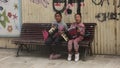 CHANIA, CRETE ISLAND, GREECE - 1 October 2021: Two young girls play accordion to earn money from at street.