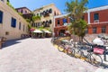 Chania, Crete - June 26, 2016: Houses of the part of Old City of Chania with cafe and the red building of Maritime Museum of Crete Royalty Free Stock Photo