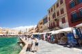 Chania, Crete - June 26, 2016: Tourists and architecture of the Old city with shops with souvenirs are located on the embankment