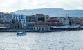 Chania Town Crete, Greece. View of outdoors cafe, seaside building. Motorboat sails in ripple sea Royalty Free Stock Photo