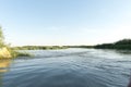 Channel landscape with waves in Danube Delta, Romania, on summer day