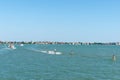 Channel markers leading between islands of Venice with boats and ferries providing transport and dome of Santa Maria Elisabetta Royalty Free Stock Photo