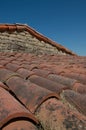 old canal tile roof with stone chimney