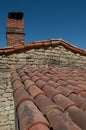 old canal tile roof with stone chimney