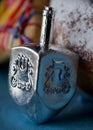 A dreidel resting against a powdered jelly donut taken Dec 2019 just before Channukah Royalty Free Stock Photo