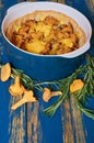 Chanterelle mushroom pie with cheese and herbs in the baking dish decorated with fresh rosemary on the wooden rustic kitchen table Royalty Free Stock Photo