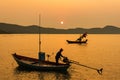 Chanthaburi, Thailand - February, 02,  2020 :Beautiful sunrise over sea with Silhouette of fishermen with yellow and orange sun in Royalty Free Stock Photo