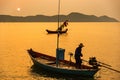 Chanthaburi, Thailand - February, 02,  2020 :Beautiful sunrise over sea with Silhouette of fishermen with yellow and orange sun in Royalty Free Stock Photo