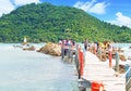 CHANTHABURI THAILAND-26 JULY 2019: travelers on the wooden bridge path to Chedi Hua Laem pagoda on rock in the sea