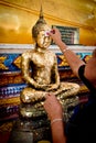 Chanthaburi , Thailand - MAY 11 : Thai Buddhist People doing cover Statue of Buddha with Gold Leaf. This is Tradition Culture