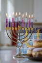 Chanukah burning candles to a Hanukkiah Menorah on a blurry background as a Jewish Religion holiday symbol