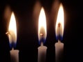 Close Up View of Three Chanukah Candles in a Dark Room