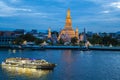 Chao Phraya River Cruise Boat with Temple of the Dawn, Wat Arun, at Sunset in Background, Horizontal