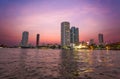 Chao Praya River in Bangkok, buildings and boats at sunset, Thailand Royalty Free Stock Photo
