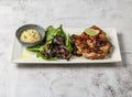 chao ta grilled chicken steak with plain rice, lemon and green leaves served in dish isolated on grey background top view of Royalty Free Stock Photo