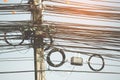 Chaos of cables and wires on electric pole. Royalty Free Stock Photo