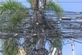 Chaos of cables and wires on an electric pole. Many electrical cable - wire and telephone line on electricity post. Wire and cable Royalty Free Stock Photo