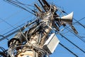 Chaos of many different data cables and network wires messy tangled hanged on concrete pillar pole on urban city street Royalty Free Stock Photo