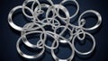 Chaotic Intertwined Silver Loops and Rings on a Dark Blue Background abstract chaos Royalty Free Stock Photo